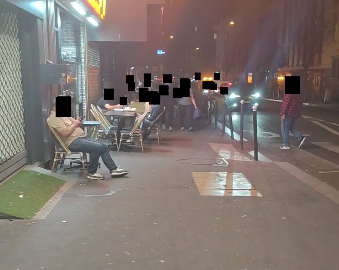 Une terrasse de nuit filmée au téléphone, chaque visage couvert d'un carré noir par vesky